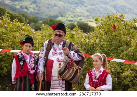 GORNO IZVOROVO, BULGARIA - MAY 30, 2015 - Rose picking ritual. People dressed in a traditional folklore costumes, sing and dance for health and successful harvest of the Bulgarian Roses.