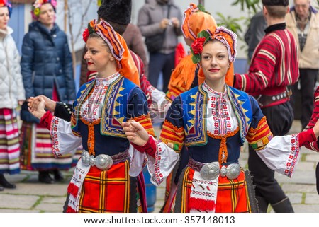 PLOVDIV, BULGARIA - NOVEMBER 29, 2015 - Young wine parade in the Old Town in Plovdiv, Bulgaria. Public wine tasting accompanied with traditional folklore dances.