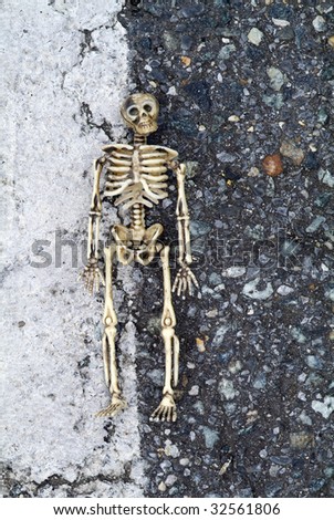 Skeleton with grungy background with dark stones and white line with skeleton in between.