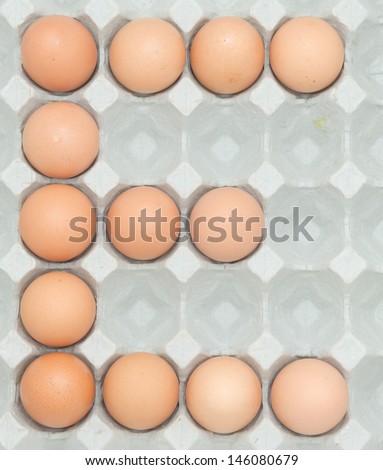 letter e  from the eggs,Eggs in paper tray isolated on white