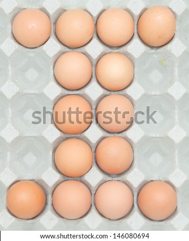 letter i  from the eggs,Eggs in paper tray isolated on white