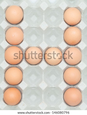 letter h  from the eggs,Eggs in paper tray isolated on white