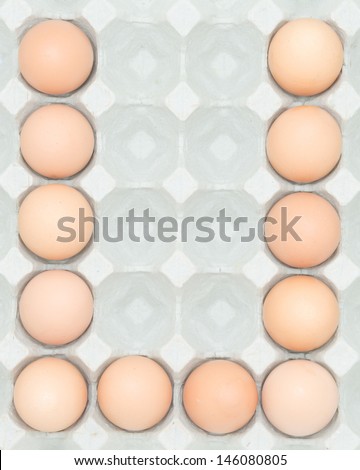 letter u  from the eggs,Eggs in paper tray isolated on white