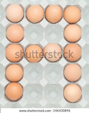 letter a from the eggs,Eggs in paper tray isolated on white