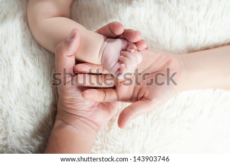 Baby hand into parents hands. Family concept