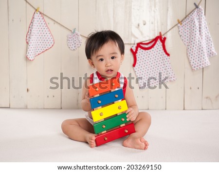 child playing with musical toy