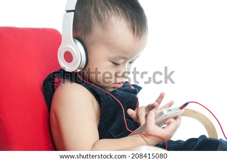 baby boy with headset using touch pad, early education and learning