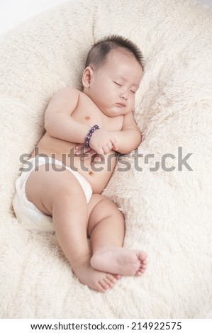 Sweet baby sleep under a white blanket. Health care child concept