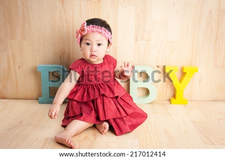 Beautiful baby girl with bow in hair smiling a happy smile