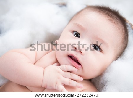 Asian baby looking straight on a white background