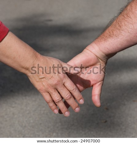 male and female hands reaching to each other