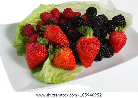 Colorful border frame made of sweet forest berries with blossom isolated on a white background Forest Fruit, strawberries, blueberries, raspberries