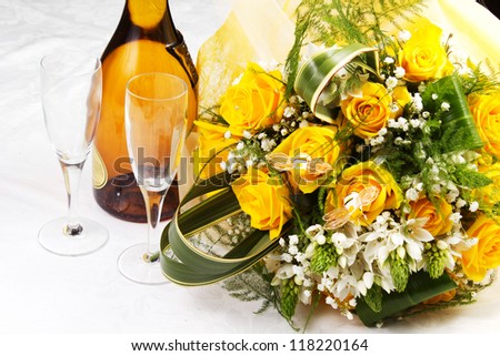 yellow rose for the san valentine day on the table with glass