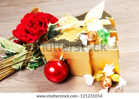 chocolate box on a table wood with rose an christmas decorations