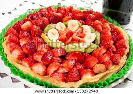 fresh fruit cake isolated with strawberries, bananas, kiwi