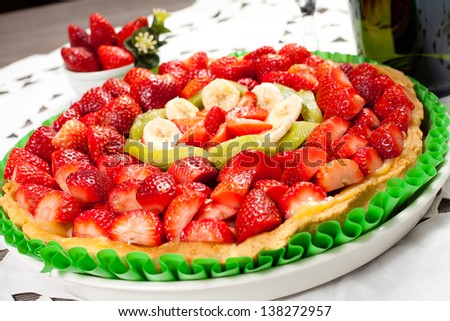 fresh fruit cake isolated with strawberries, bananas, kiwi