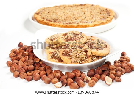 hazelnut and chocolate cookies and cake on a white background
