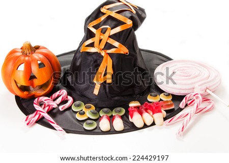 Halloween party decorations with carved pumpkins, marshmallows and witch hat