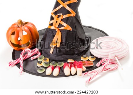 Halloween party decorations with carved pumpkins, marshmallows and witch hat