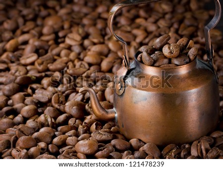 Coffee pot with light roasted coffee beans, selective focus
