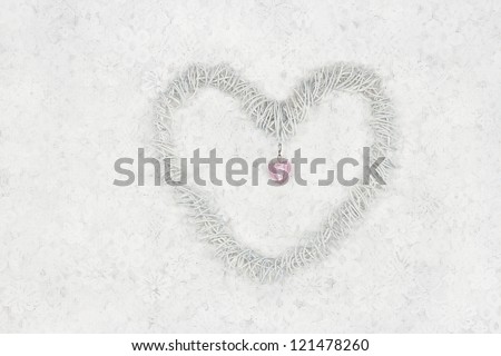 Decorative heart on white lace background with small pink heart