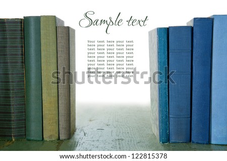 Old green and blue books on wooden rustic background, isolated on white