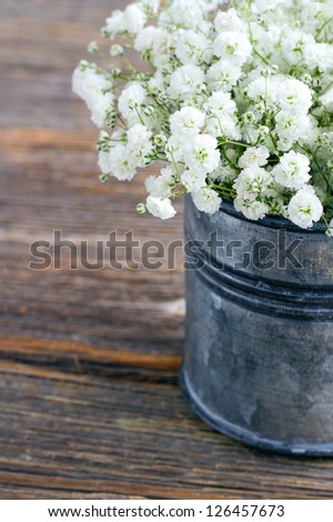 Bouquet of white baby\'s breath flowers (Gypsophila) on wooden rustic background