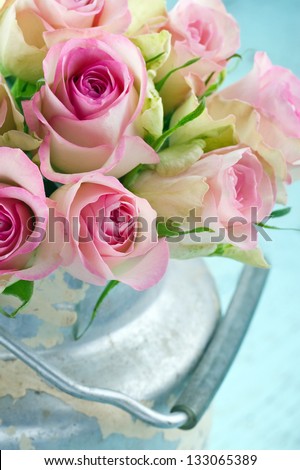 Bouquet of pink romantic roses in a rustic shabby chic bucket