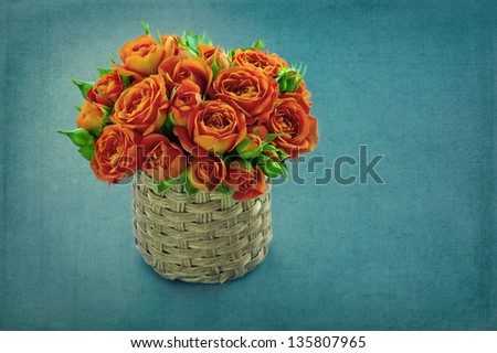 Bouquet of orange roses on a blue vintage shabby chic background with copy space