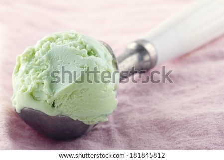 Scoop pf green pear ice cream pink background with vintage hazy editing