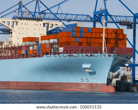 Huge container cargo  ship moored to a wharf