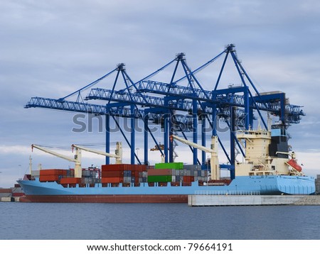 Huge container cargo  ship moored to a wharf
