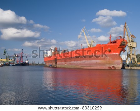 A huge red ship during hull repair