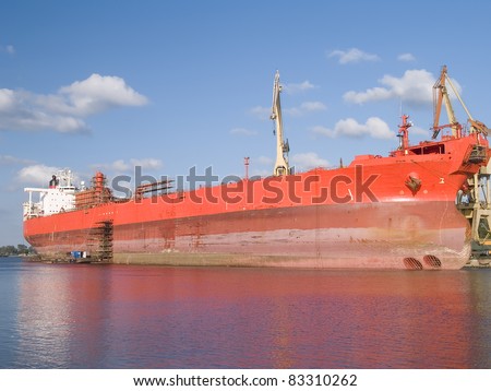 A hug red ship during hull repair