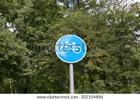 Round blue sign road cycling in the city park