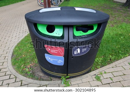 Plastic city urn with separate waste collection on the lawn
