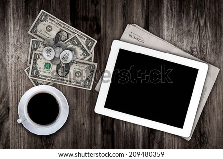 before work newspaper, coffee, tablet  and money on the table