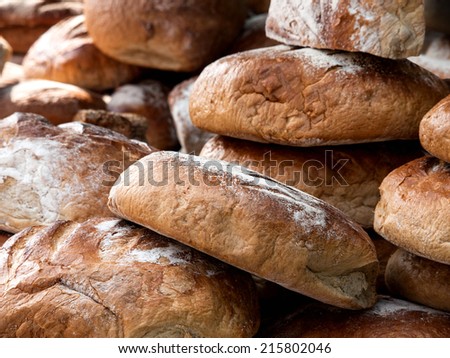 Big pile of freshly baked bread for sale on market