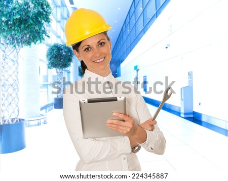 Woman engineer with the tablet and wrench in hands