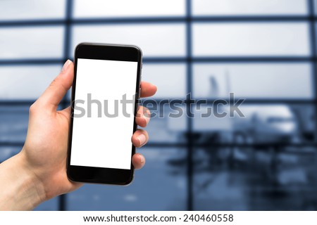 phone in the hand with a blank screen and a plane in the background