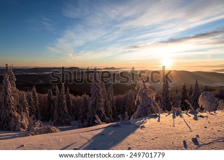 Winter landscape in mountains in the morning. The sun\'s rays and flare.