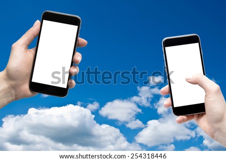 phones in the hands of a blank screen on a background of the sky