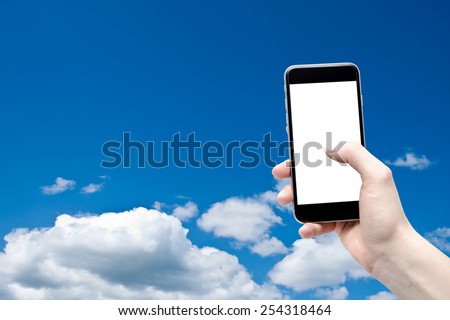 phone in the hand with a blank screen on a background of the sky