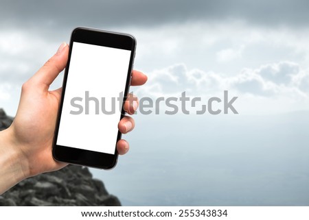 phone in the hands of women and mountains in the background
