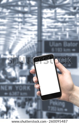 Phone in the hands of the woman at the airport. Blurred background.