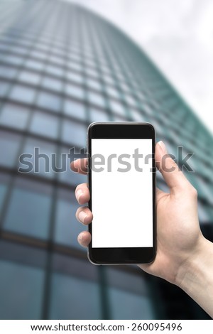 Skyscraper and the phone in his hand. Wide angle of view from below.