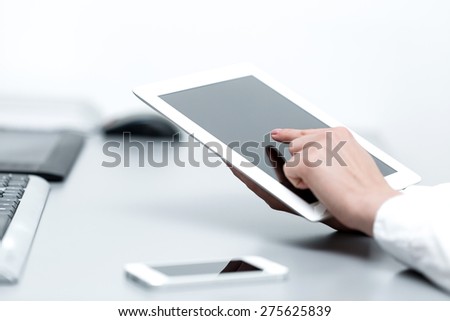 close up hands multitasking woman using tablet, around the blurred background