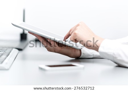 close up hands multitasking woman using tablet, laptop and cellphone connecting wifi in office