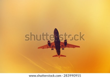 passenger plane take-off from airport at sunset