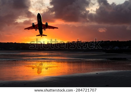 passenger plane take-off from airport at sunset